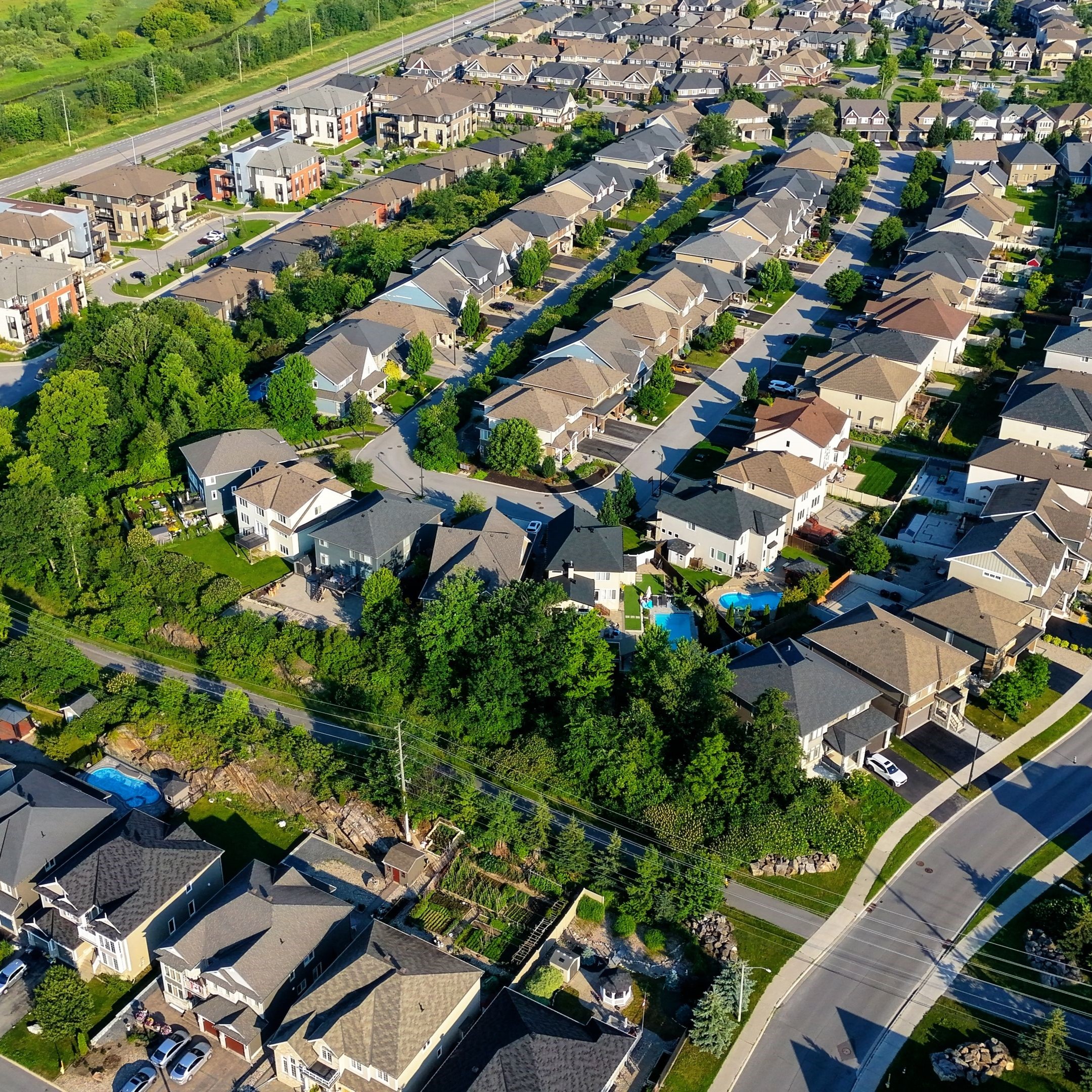 Aerial view of a residential neighborhood with well-maintained properties and landscaped yards